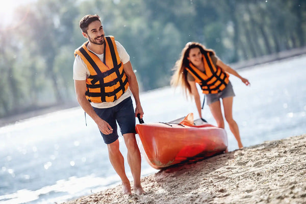 Orange kayak being carried.
